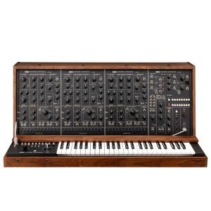 Front view of a vintage Korg PS-3300 polyphonic analog synthesizer, featuring three large panel sections filled with knobs, sliders, and patch cables, with a full 48-key keyboard beneath