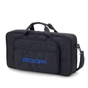 emi-hard carrying bag—black exterior, padded interior with blue lining, designed for Zoom G11 Multi-Effects Processor; features top handle and detachable padded shoulder strap